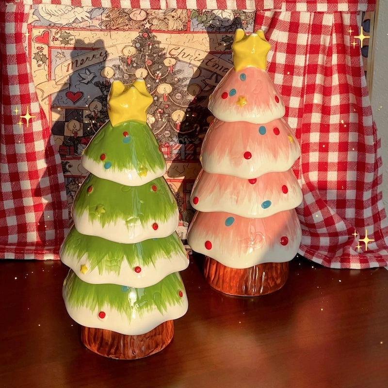 Green and pink ceramic Christmas tree set displayed against a red checkered Christmas backdrop