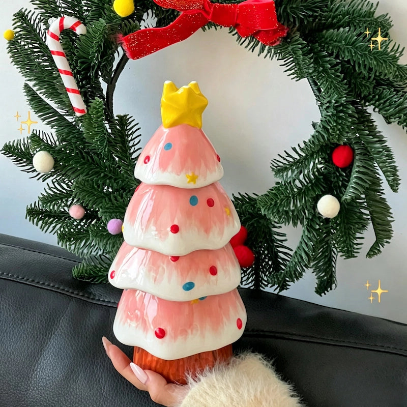Ceramic Christmas tree tea set displayed on a wooden table with festive background